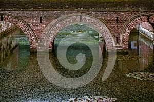 Beautiful historic double-bore bridge made of bricks at Commanderij Aldenbiesen, Bilzen, Belgium.