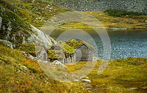 A beautiful, historic stone buildings in the mountains of Folgefonna National Park in Norway. Old houses with grass roofs near the