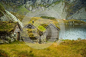 A beautiful, historic stone buildings in the mountains of Folgefonna National Park in Norway. Old houses with grass roofs near the