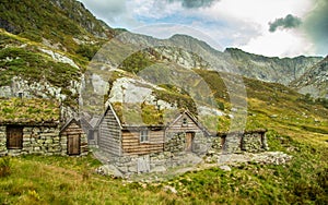 A beautiful, historic stone buildings in the mountains of Folgefonna National Park in Norway. Old houses with grass roofs near the