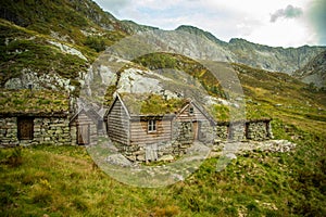 A beautiful, historic stone buildings in the mountains of Folgefonna National Park in Norway. Old houses with grass roofs near the
