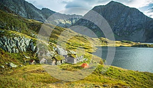 A beautiful, historic stone buildings in the mountains of Folgefonna National Park in Norway. Old houses with grass roofs near the