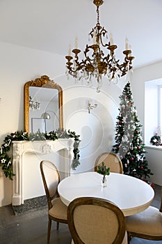 Beautiful holdiay decorated room with Christmas tree with presents under it