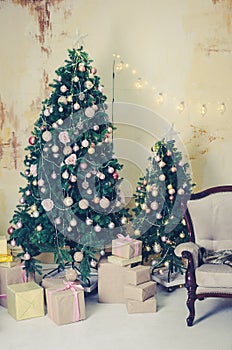 Beautiful holdiay decorated room with Christmas tree with presents under it