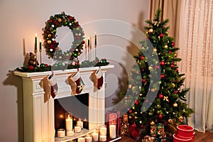 Beautiful holdiay decorated room with Christmas tree with presents under it. Fireplace and decorated Christmas tree un Living room