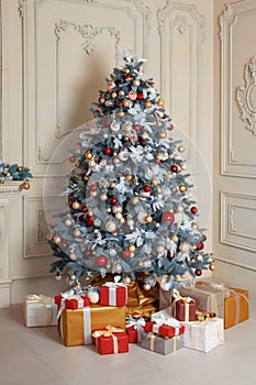 Beautiful holdiay decorated room with Christmas tree and presents under it. New Year decorations