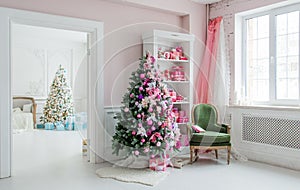 Beautiful holdiay decorated rooms with Christmas trees, shelf and pink blue gifts on it, green chair home interior