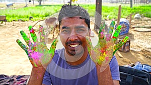 Beautiful Holi colored face and palm of kids. Adorable child friends playing Holi and making fun