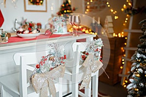 Beautiful holiday decorated kitchen with Christmas tree and bright lights , blur background