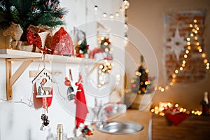 Beautiful holiday decorated kitchen with Christmas tree and bright lights , out of focus shot for photo background