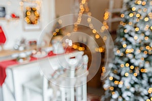 Beautiful holiday decorated kitchen with Christmas tree and bright lights , out of focus shot for photo background