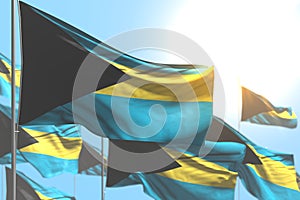 Beautiful holiday flag 3d illustration - many Bahamas flags are waving against blue sky image with selective focus