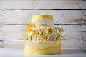 Beautiful home yellow wedding three-tiered cake decorated with red spring flowers. Concept floral trends in desserts