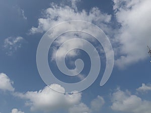 A beautiful horizontal shot of bright blue sky with puffy white clouds.