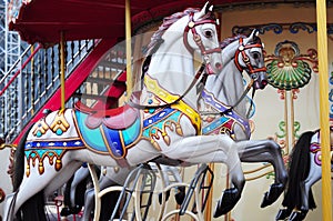 Beautiful horse Christmas carousel in a holiday park. Two horses