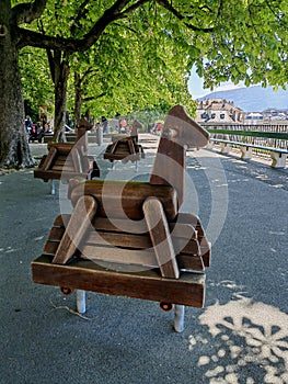 Beautiful horse wooden rocking chairs in public park near promenade de la Treille Geneva.