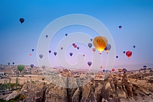 Beautiful hot air balloons flying over Cappadocia landscape at sunrise