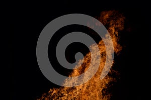 Beautiful hot burning tall flames from bonfire on dark winter background