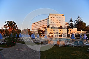 Beautiful hotel - beach resort at sunset. Summer background for travel and holidays. Greece Crete.