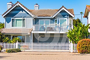 Beautiful house with  nicely landscaped front the yard and clear blue sky on background in small beach town