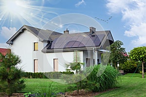 Beautiful house with solar panels. Clear sky an sun. ECO CONCEPT photo