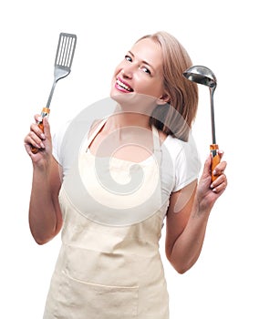 Beautiful housewife with ladle and spatula. Isolated on white ba