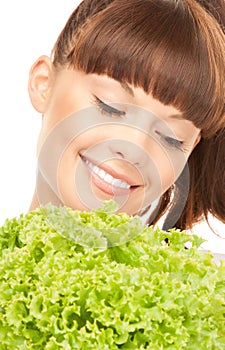 Beautiful housewife with lettuce over white