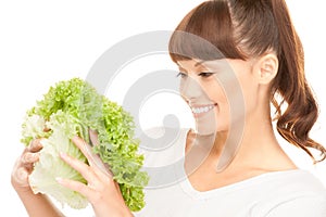 Beautiful housewife with lettuce over white