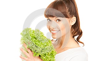 Beautiful housewife with lettuce over white