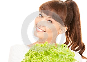 Beautiful housewife with lettuce over white