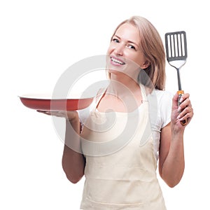 Beautiful housewife with spatula. Isolated on white background