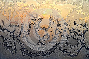 Beautiful ice pattern and bright sunlight on winter glass