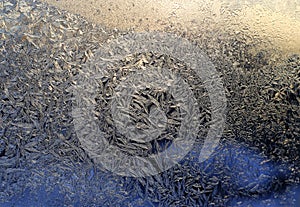 Beautiful ice pattern and sunlight close-up on winter glass