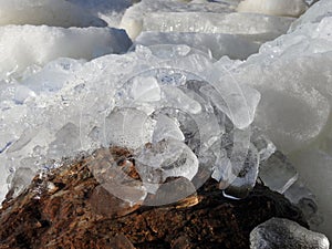 Beautiful ice pieces near big stone