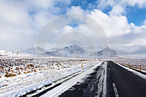 Beautiful Iceland road heading to snow capped mountain with nice