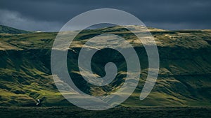 Beautiful icelandic scenery with dark sky. grassland in iceland