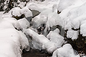 Beautiful icy waterfall in the forest. Vosges mountains.