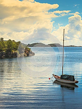 Beautiful idyllic lake landscape, swimming drifting yacht