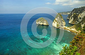 Beautiful idyllic scenic view of sea landscape at tropical island paradise beach with diamond rock cliff mountains and turquoise