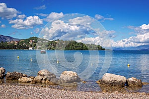 Beautiful idyllic summer landscape with calm sea, boat, blue sky and white clouds