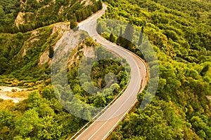 Beautiful idyllic summer landscape of Toscana with road, hills, trees and forests photographed with drone.