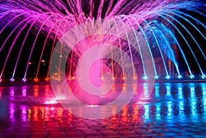 Beautiful illuminated colorful city fountain at night time