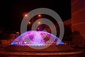 Beautiful illuminated colorful city fountain at night time