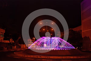 Beautiful illuminated colorful city fountain at night time