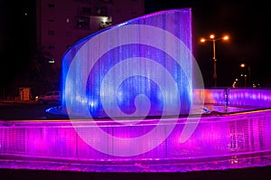 Beautiful illuminated colorful city fountain at night time