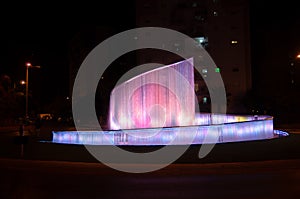 Beautiful illuminated colorful city fountain at night time