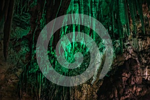 Beautiful illuminated limestone stalactites in Adygeya underground cave photo