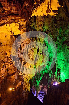 beautiful illuminated multicolored stalactites from karst Reed Flute cave. Guilin Guangxi China