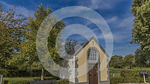 Beautiful image of a chapel surrounded by trees and green vegetation photo