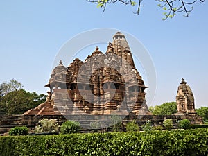 Beautiful image of Kandariya Mahadeva temple, Khajuraho, Madhyapradesh, India with blue sky and fluffy clouds in the